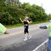 A participants gestures while running by a water station during the Ann Arbor Marathon on Sunday, June 9. Daniel Brenner I AnnArbor.com